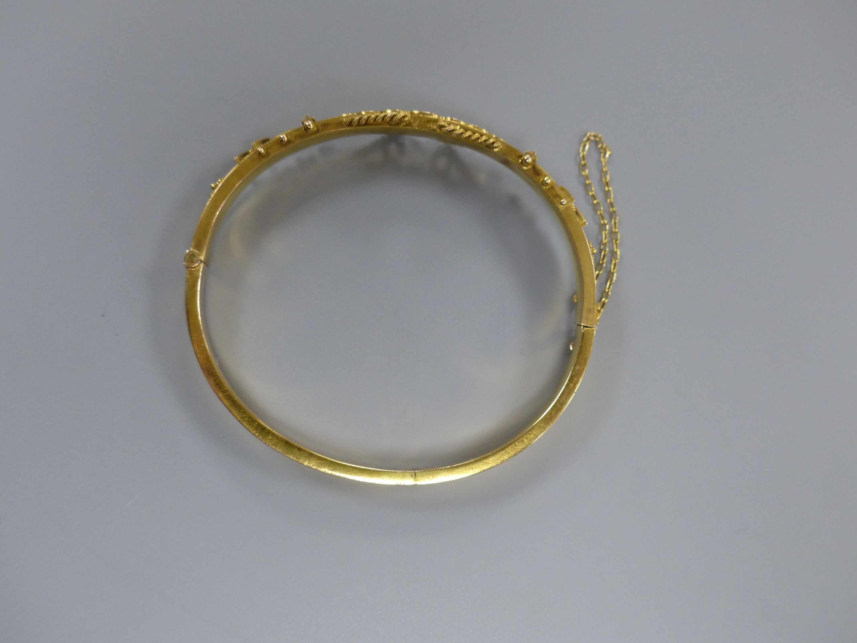 An Edwardian 9ct, sapphire and rose cut diamond chip set hinged bangle,